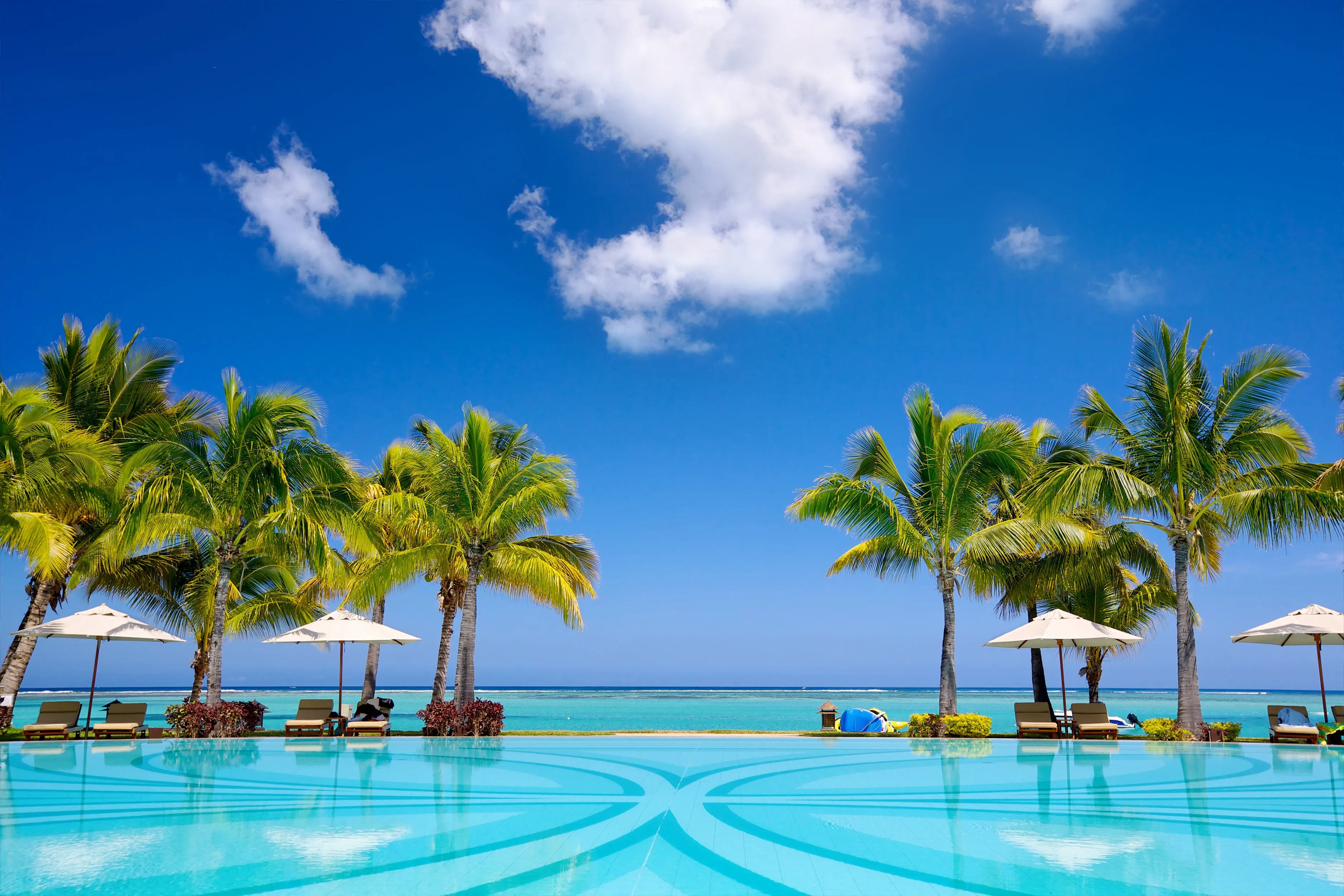 Hotel pool with beach front view in paradise
