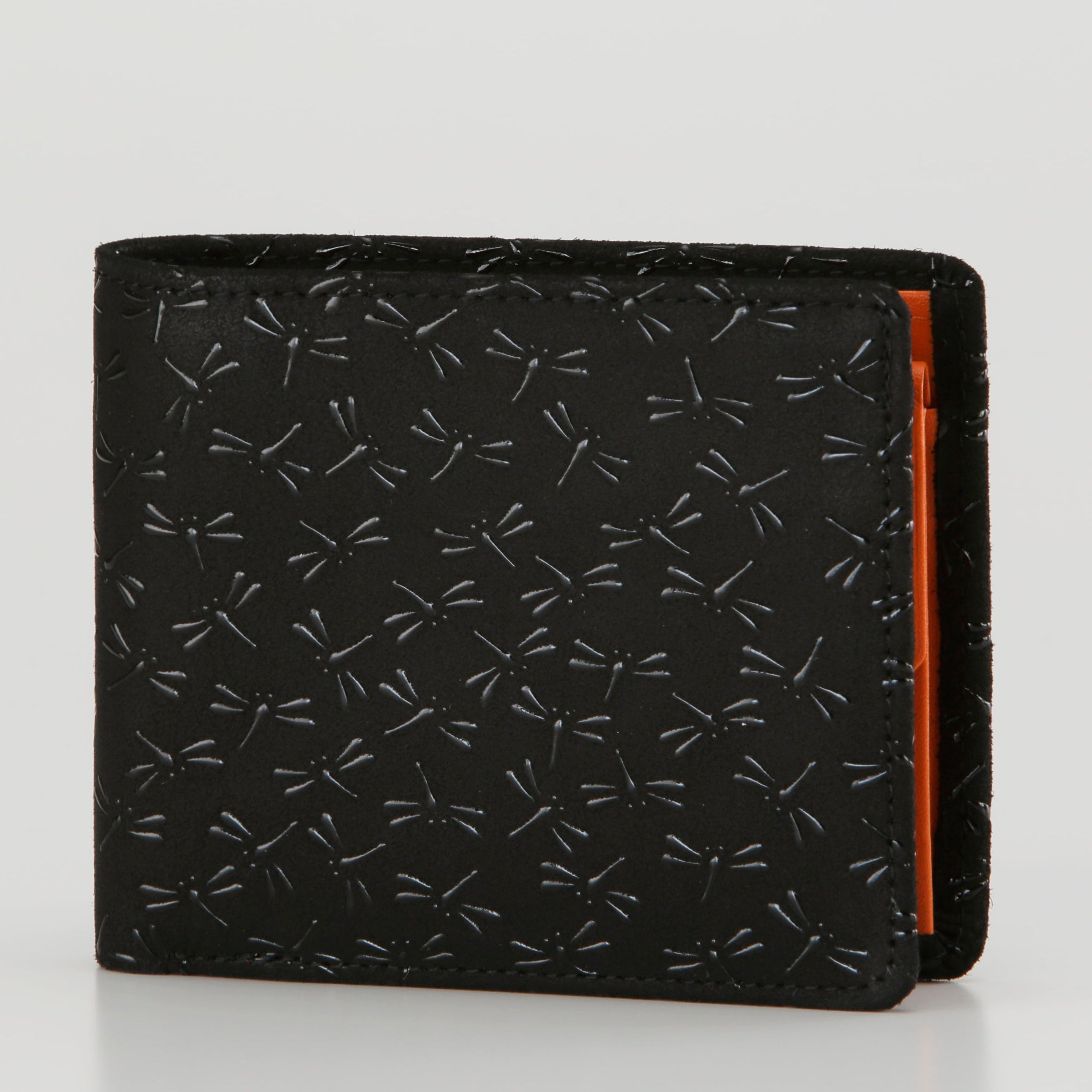 Black wallet with orange interior lining on a light gray background