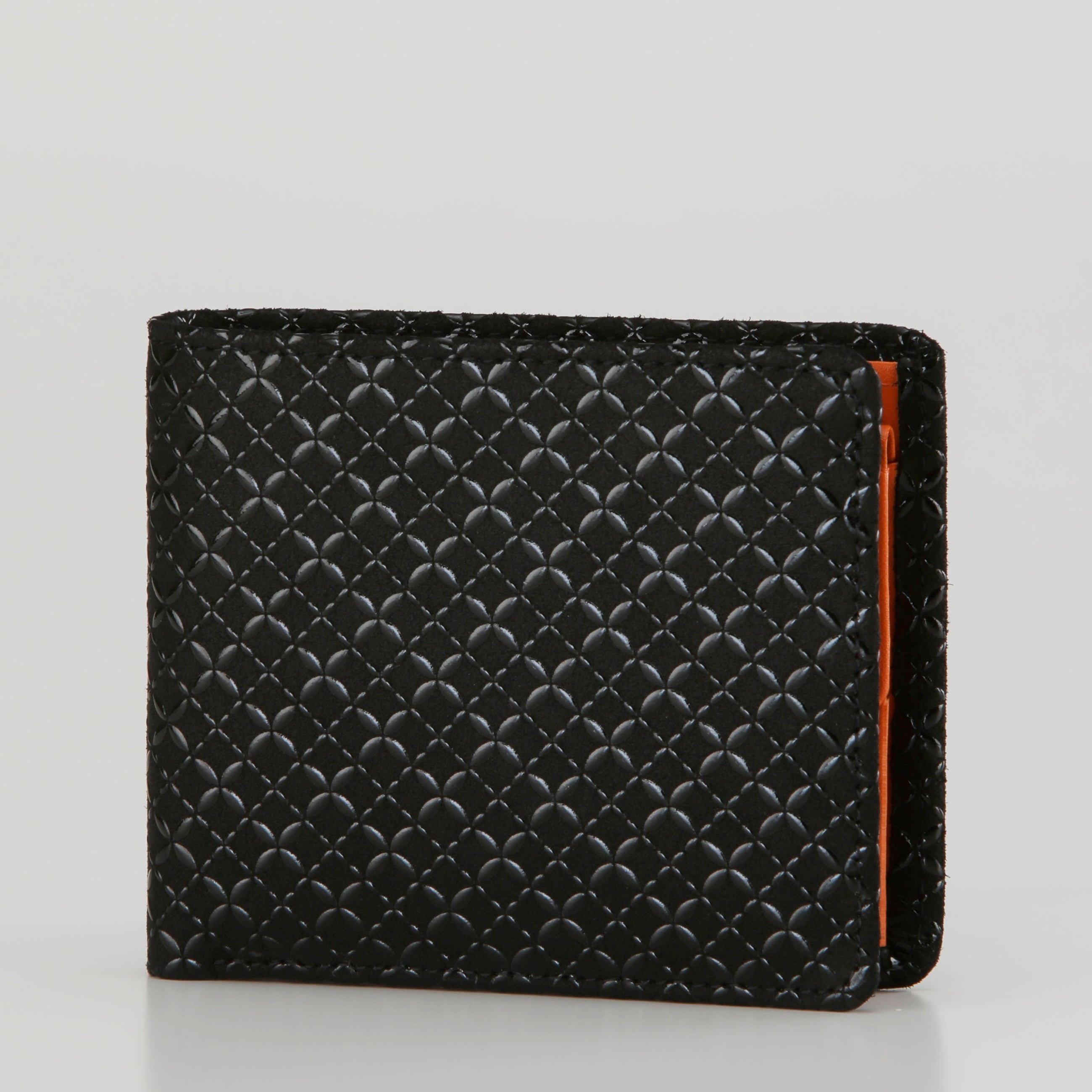 Black textured wallet with orange accent on a light gray background