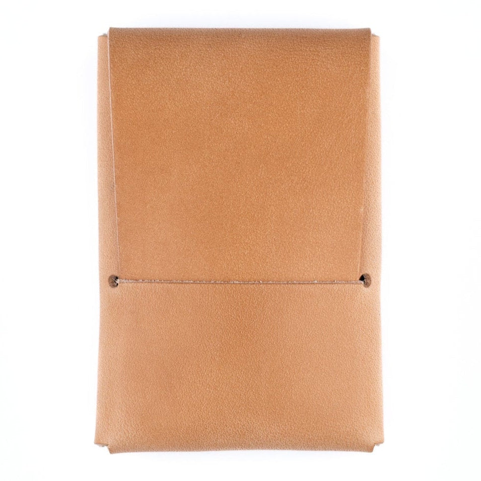 Tan leather notebook on a white background