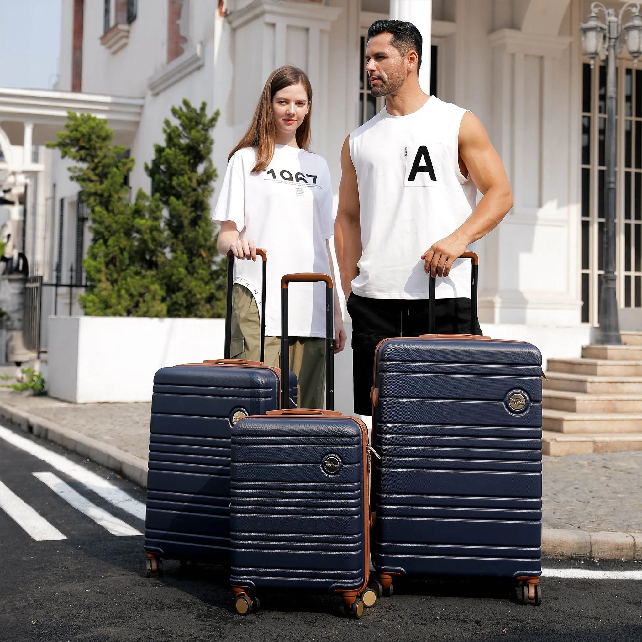 Miami CarryOn Brickell Luggage Set in Navy modeled by a man and a woman