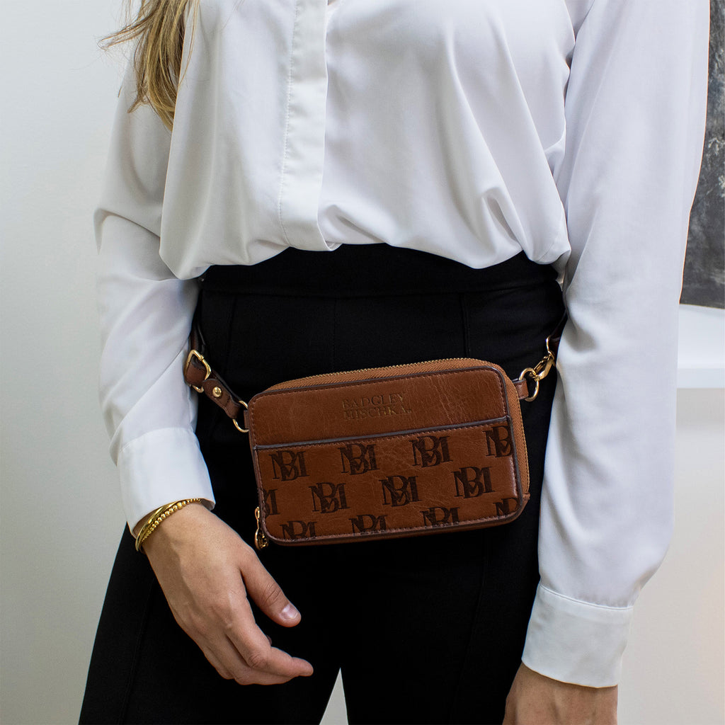 woman wearing vegan leather belt bag by badgley mischka