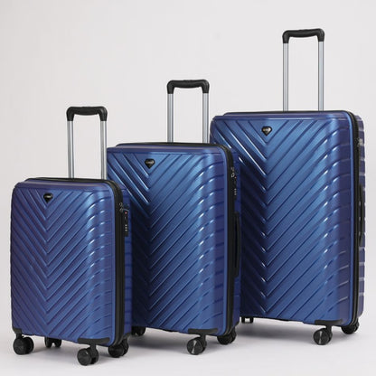 Set of three blue suitcases with chevron pattern on a light gray background