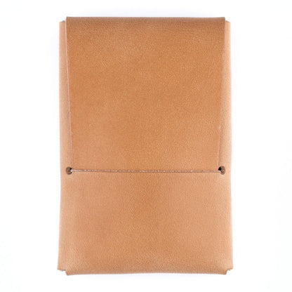Tan leather notebook on a white background