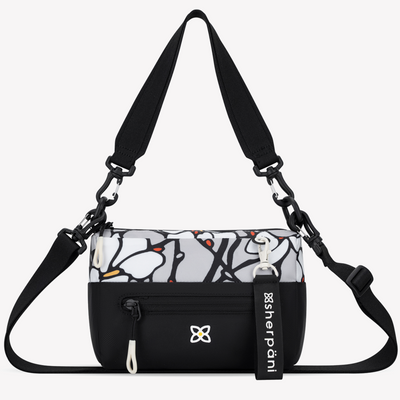 Black crossbody bag with a patterned compartment and visible Sherpani branding on a white background