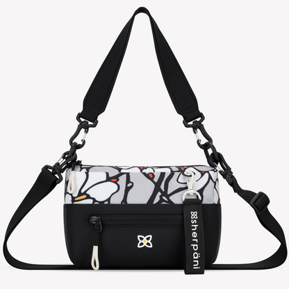 Black crossbody bag with a patterned compartment and visible Sherpani branding on a white background