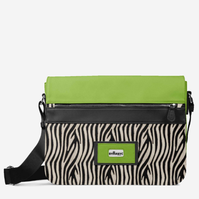 Crossbody bag with zebra pattern and green accents on a white background