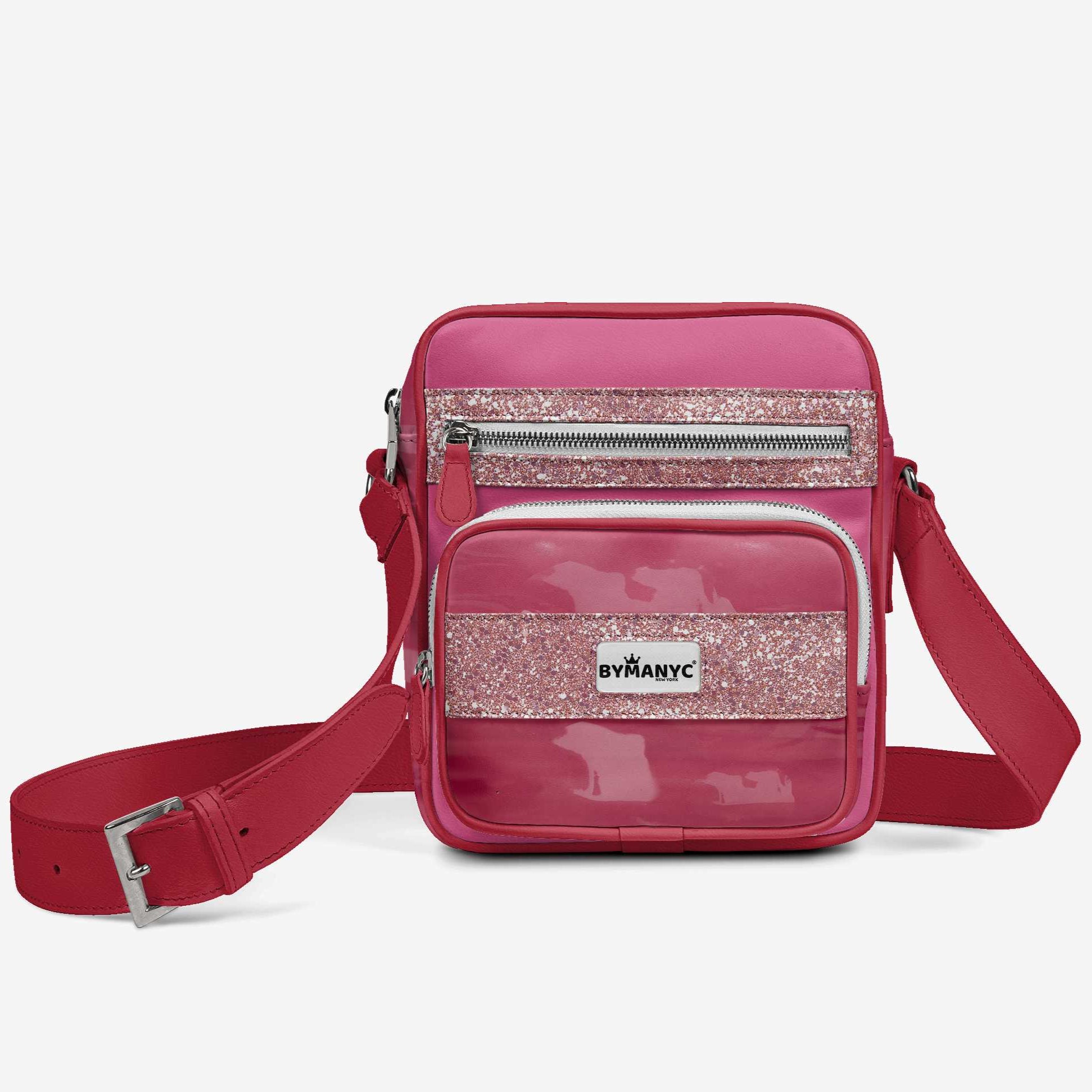 Pink crossbody bag with glittery accent and By Any Means logo on a white background