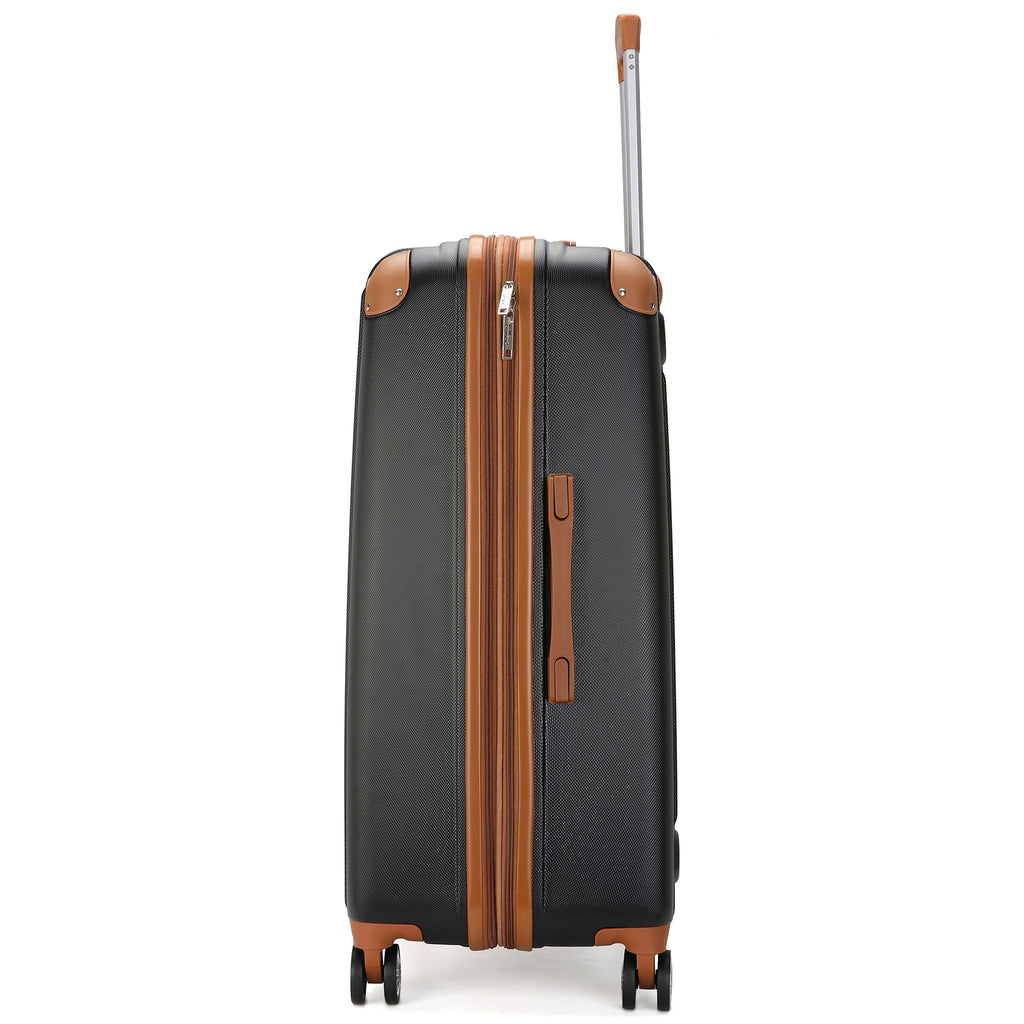 sideview of black luggage with brown accents and corner guards and adjustable trolley handle