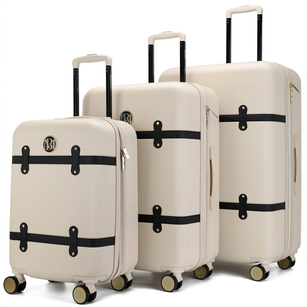 champagne colored luggage 3 piece set with black straps by badgley mischka