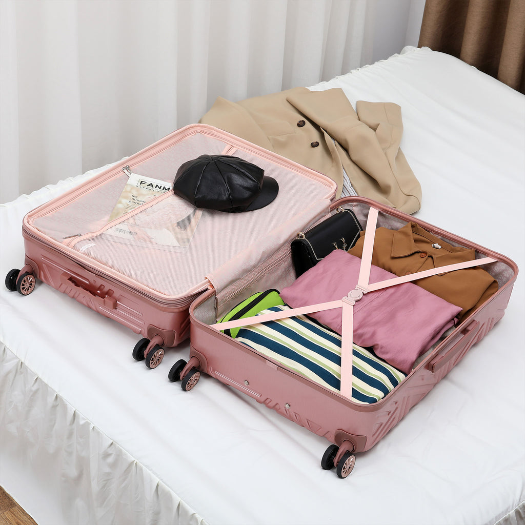 Pink women's luggage with clothing packed in it to show compartments and straps