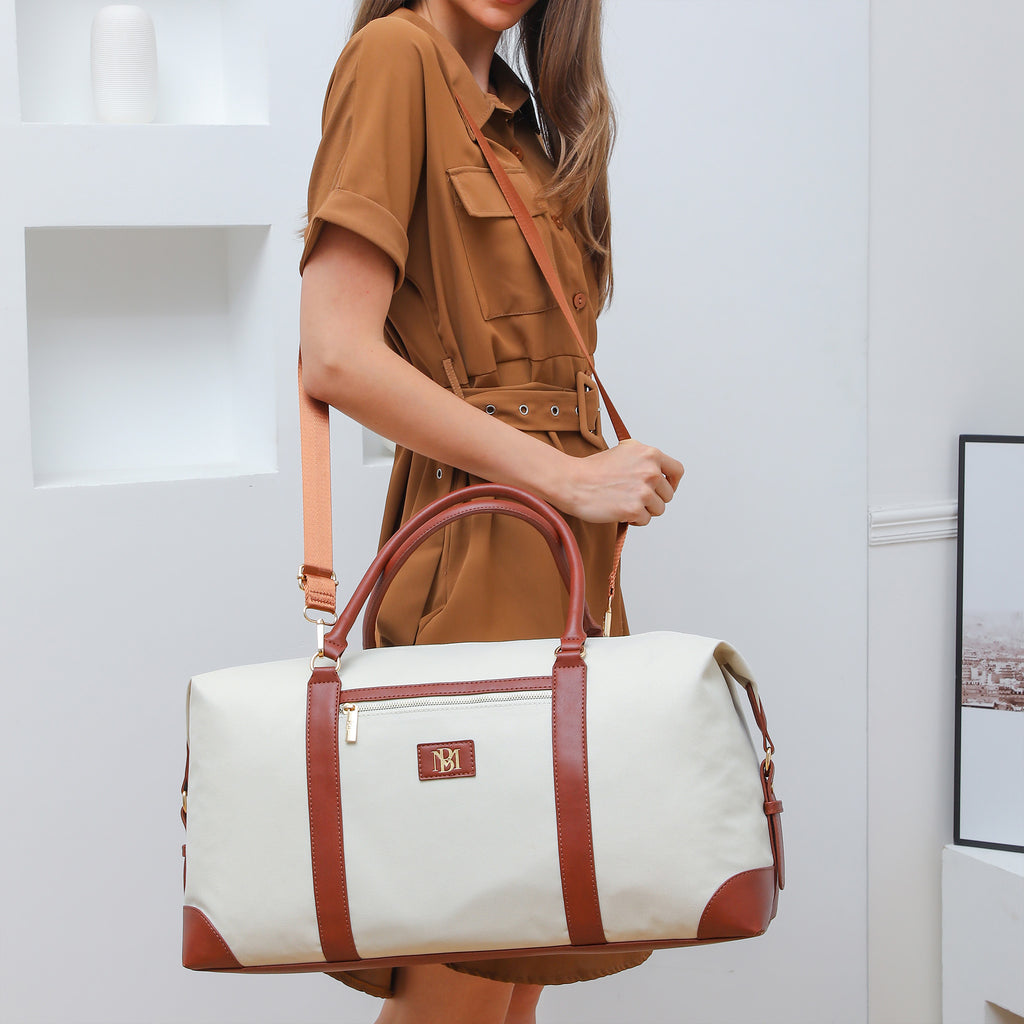 white duffle bag with leather straps