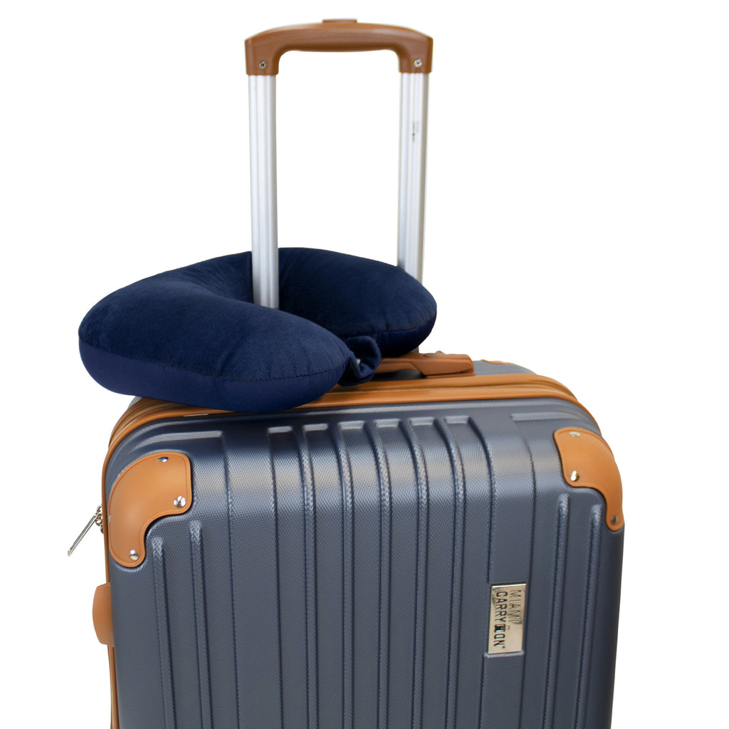 navy neck pillow attached to luggage handle
